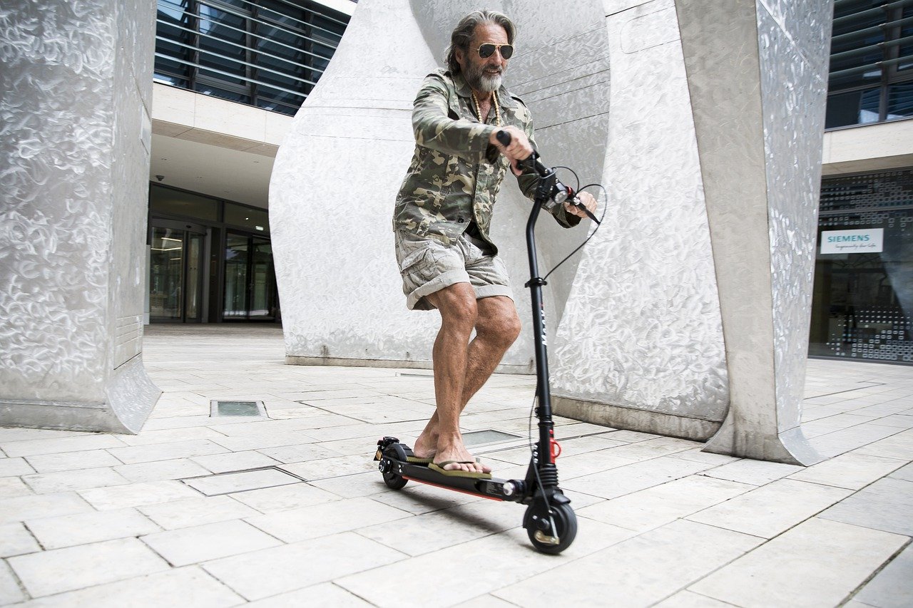 man on electric razor scooter